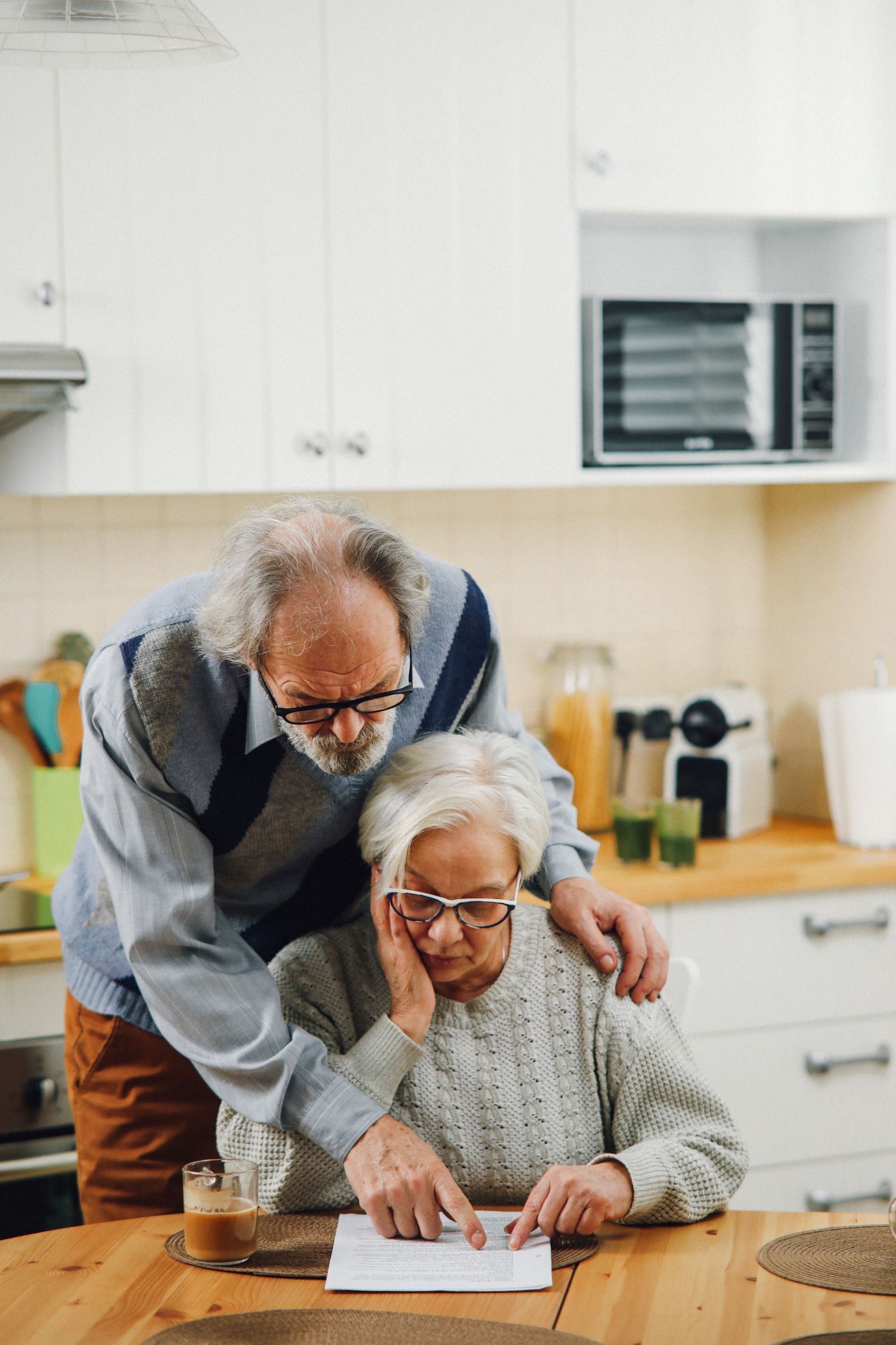 A couple reviewing documents together at their kitchen table